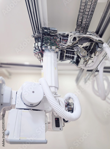 An intricate view of the mechanical and electronic components of an X-ray machine, showcasing the precision engineering that powers the diagnostic process in healthcare.