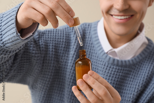 Young man with bottle of CB...