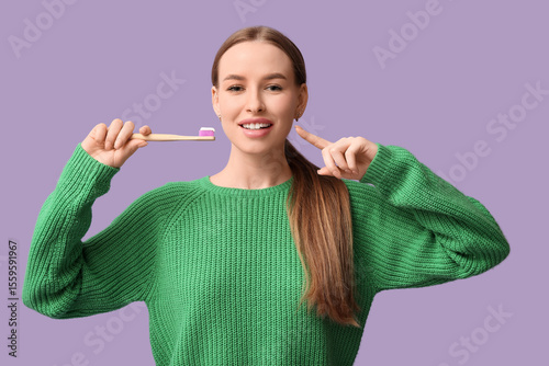 Young woman with toothbrush...