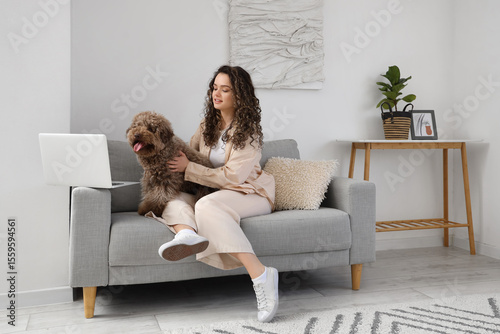 Young woman with cute poodl...