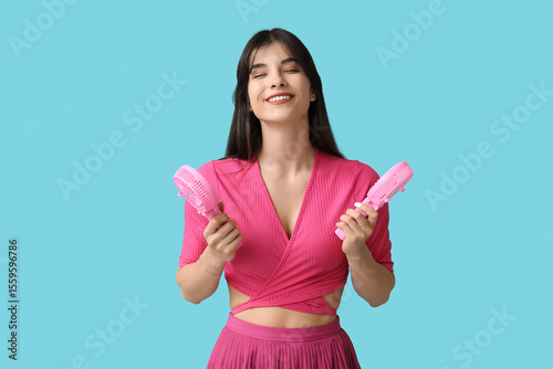 Young woman with mini fans ...