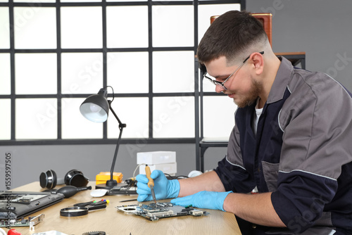 Male technician repairing P...