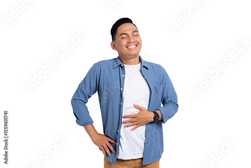 Portrait of young Asian man in casual shirt feeling happy after eating delicious food and rubbing his belly isolated on transparent background