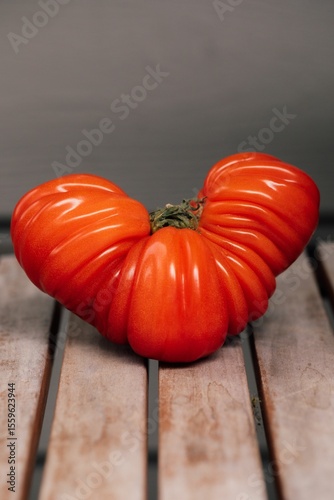 bright red heirloom tomato on wood table