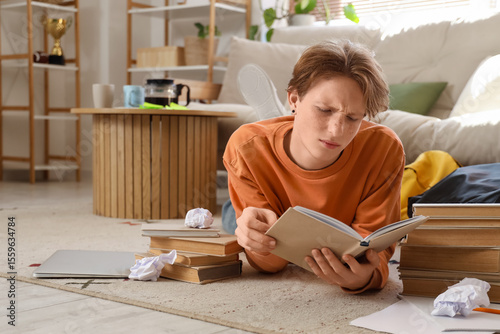 Stressed male student readi...