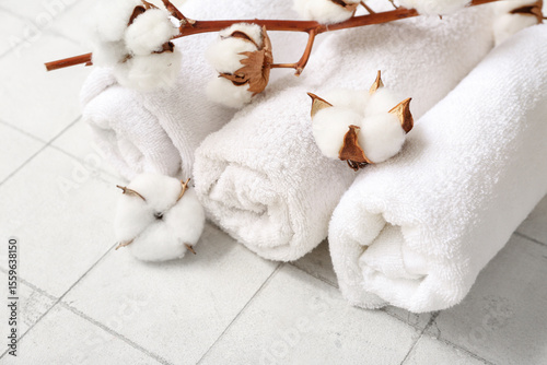 Rolled clean towels and cot...