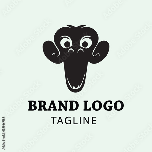 Simple black monkey logo design with wide open mouth and large ears on light mint background. Creative logo for a business or organization.