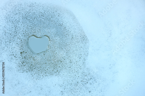 Detergent foam bubbles on a water with cleaning or washing, Close up of soap bubbles