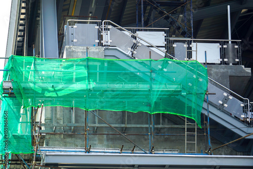 Green slanding net is used to cover the electric train base structure, used for temporary wall around construction site, fence prevents dust from construction site.