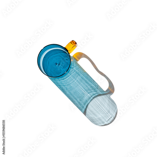 Blue colored glass mug with beautiful sunlight shadows isolated on white. Top view blue glass cup with Refraction at shine drink, caustic effect, minimal aesthetic top view summer life style