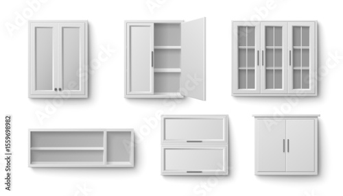 White kitchen cabinet collection in various storage styles. Different wall mounted units with glass doors, open shelving, closed panel fronts and upper furniture pieces for modern home organization.