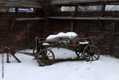 an old cart loaded with sacks stands near the wooden walls of the fortress