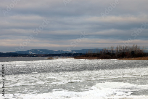 Winter landscape in Bashkiria - lake, ice, mountains