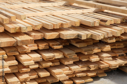 Stack of wooden boards used on the construction site. Construction material, building supplies, timber, lumber, woodworking, carpentry business, lumberyard, sawmill, house building