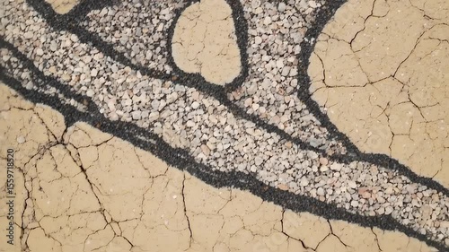 Intricate Patterns of Cracked Earth and Sandstone Layers A Detailed Close-Up