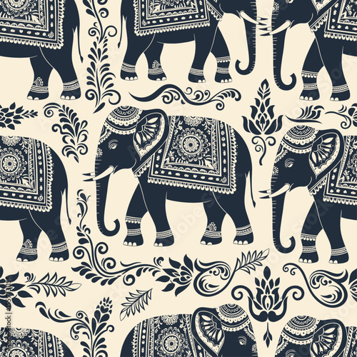 An elegant, seamless pattern featuring ornate, caparisoned Indian elephants and intricate paisley floral motifs in a dark blue and cream color scheme. Vector Patterns