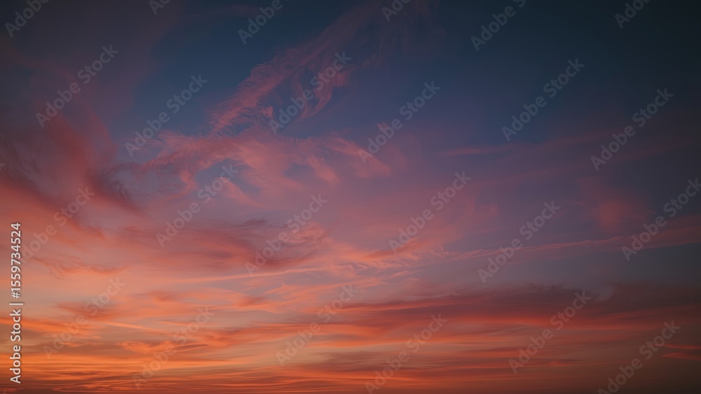 Obraz premium Magnificent sky at sunset painted in vibrant hues of orange, pink, and purple, with soft clouds drifting across the glowing horizon, creating a serene and breathtaking view of nature’s evening beauty