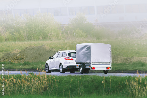 Car towing trailer during golden sunset drive