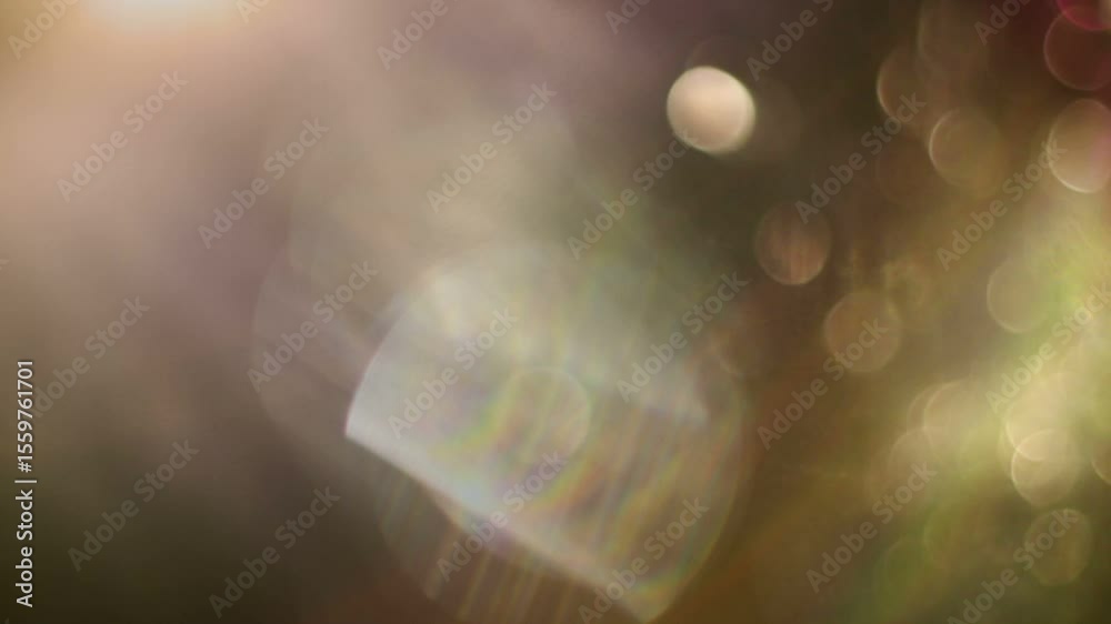 A seamless loop of a beautiful and soft bokeh light leak overlay, featuring gently shifting, out-of-focus purple and orange lights perfect for a dreamy, atmospheric background