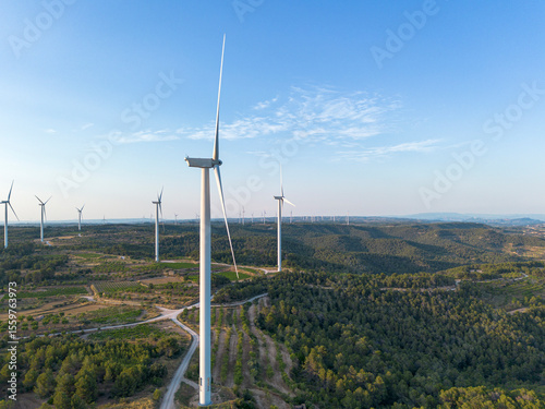 Elevated aerial view of multiple wind turbines in Terra Alta, Catalonia, Spain, highlighting renewable energy sources and green environmental practices