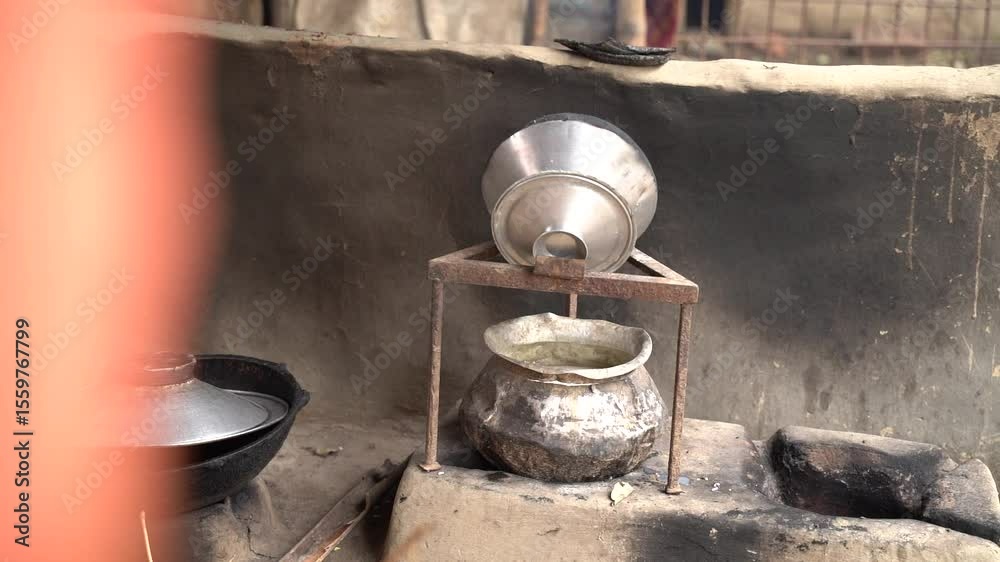An old-fashioned metal oil lamp on the wall casts a warm flame, reminiscent of a blacksmith's forge or a rustic kitchen stove, burning wood for heat and cooking