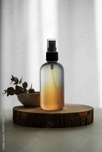Wallpaper Mural Photo of a frosted amber glass spray bottle sits on a wooden slice, next to eucalyptus leaves Torontodigital.ca