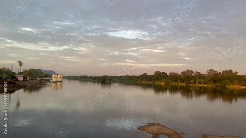 Small River Flows Gently Through SunsetLit Golden Landscape