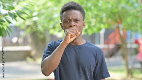 Portrait of Sick Casual African Man Coughing Outdoors