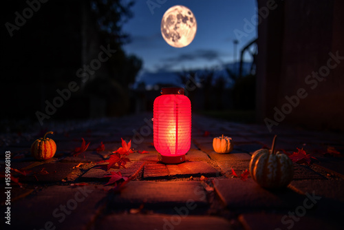 Glowing lantern with pumpkins and autumn leaves fall