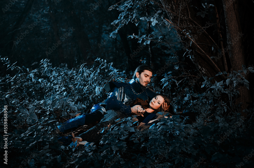 Fototapeta premium A scene depicting a medieval knight and maiden in armor and attire, embracing amidst a dimly lit forest. Represents fantasy, medieval romance, and the heartfelt connection between two individuals.