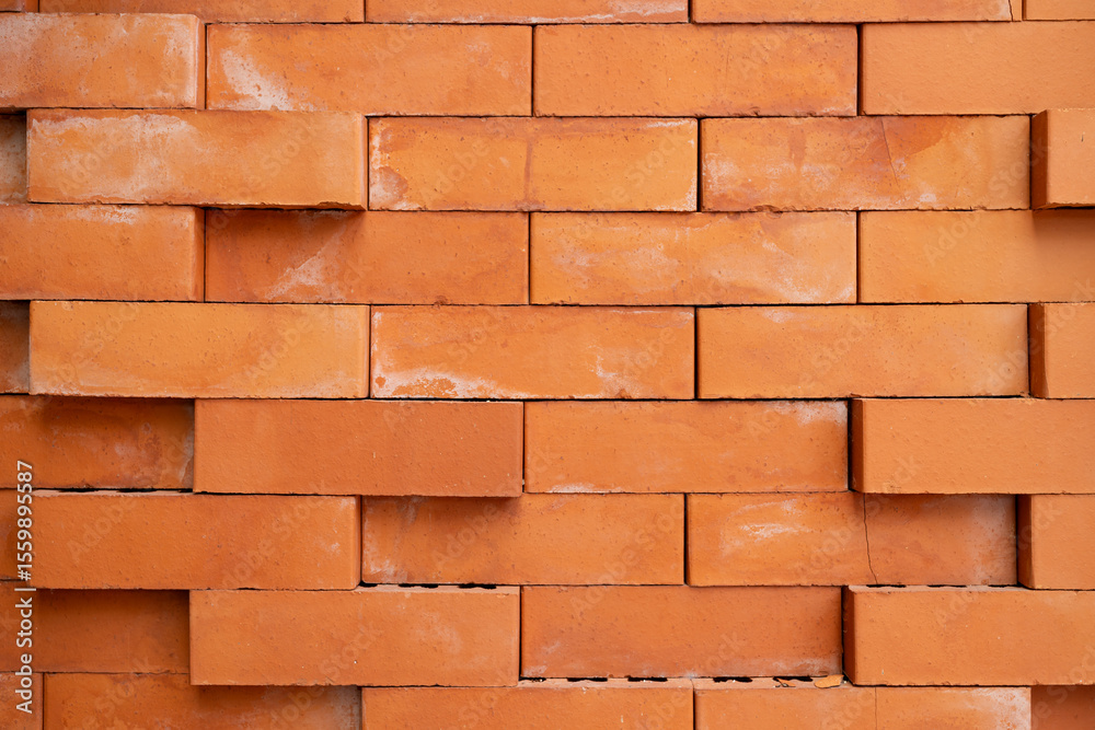 Obraz premium Orange Brick Wall with Rough Texture. Perfect for backgrounds, construction themes, architectural designs, and texture overlays.