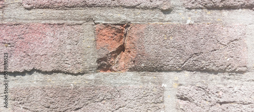 Chip inside a brick on a Weathered brick wall showing different textures. Close-up