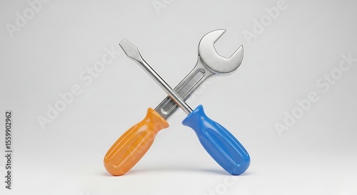 A wrench and a screwdriver crossed against a plain white studio background view