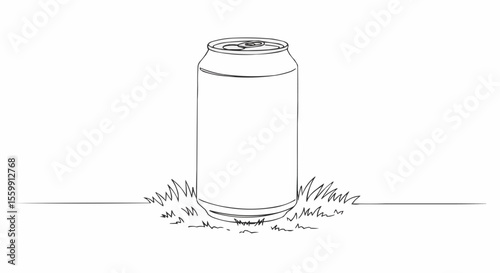 A can of soda rests on the grass. 