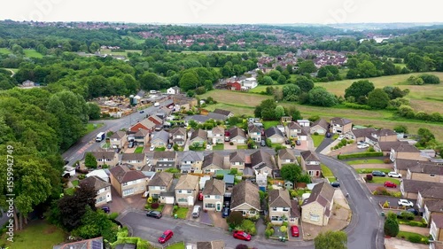 Aerial footage of the town of Cleckheaton in the metropolitan borough of Kirklees, West Yorkshire England showing a drone view of a typical British housing estate from above in the summer time