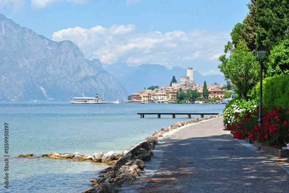 Naklejka premium View of Mountains Lake Garda and Malcesine from Footpath on Sunny Day