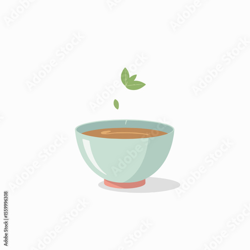 Tea with mint in a ceramic bowl displayed on clean backdrop for presentation. Tea with mint is a relaxing and delicious beverage with fresh green leaves floating on top.
