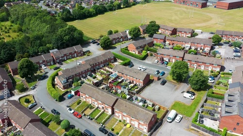 Aerial footage of the village of Birkenshaw in the borough of Kirklees in the county of West Yorkshire Bradford showing a typical British housing estate surrounded by playing fields and streets