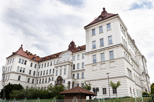 Corner tower and sweeping wings of Brno University of Technology lit by soft midday light, Czech Republic education icon
