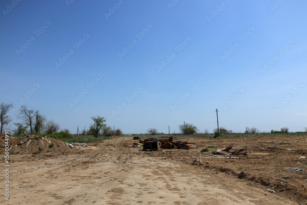 Fototapeta premium Field, warehouse, remnants, weapons, war, Russians, de-occupied, territory, destruction, aftermath, conflict, ruins, military, debris, abandoned, damaged, landscape, recovery, history, danger, evidenc