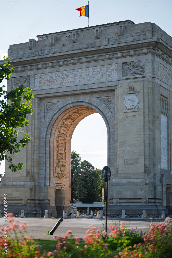 Fototapeta premium The famous triumphal arch monument in Bucharest, Romania, a popular European travel destination and symbol of history and victory, on a clear summer day.