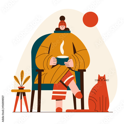A woman in warm clothes sits in a chair at home and drinks hot coffee, with a ginger cat nearby.