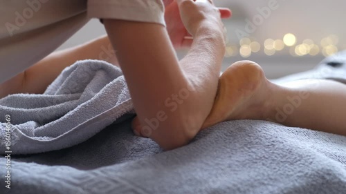 Woman receiving leg massage in spa center, Foot massage in spa salon.