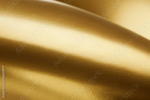 A smooth, curved surface with a metallic gold finish. The surface has a soft, matte texture and creates gentle undulating waves that flow from left to right.