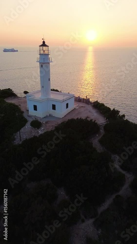 Aerial view of Lefkada lighthouse at sunset, Cape Doukato in Greece surrounded by sea