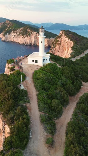 Aerial view of Lefkada lighthouse at sunset, Cape Doukato in Greece surrounded by sea