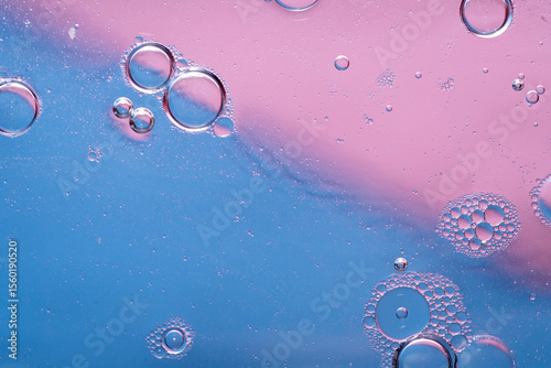 abstract background oil in water droplets, foam, and crystal shapes, on pink and blue diagonal texture, copy space