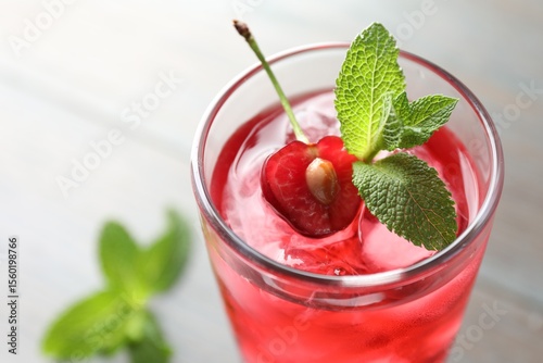 Wallpaper Mural Tasty cherry soda water with ice cubes, berry and mint in glass on light table, closeup Torontodigital.ca