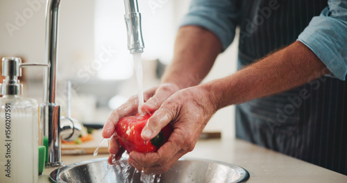 Washing, vegetables and person in kitchen, hands and cleaning for hygiene and dirt removal in house. Home, water and rinsing of bell pepper for freshness, nutrition or prevention of germs or bacteria