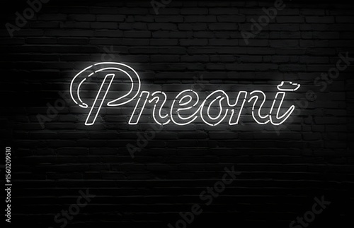 Vibrant neon sign illuminates a textured wall of black-painted exposed brick, creating a dramatic urban atmosphere.